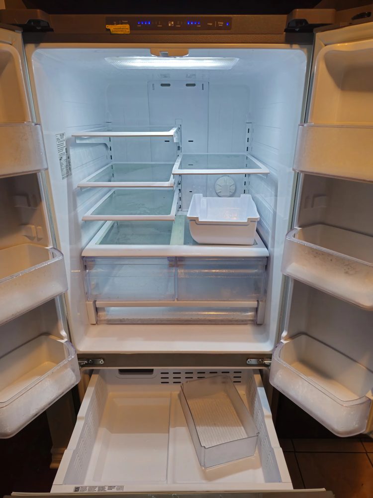 Refrigerator interior wiped down and sanitized after cleaning