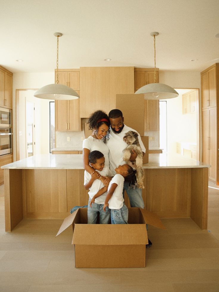 A family unpacking moving boxes together in their new kitchen